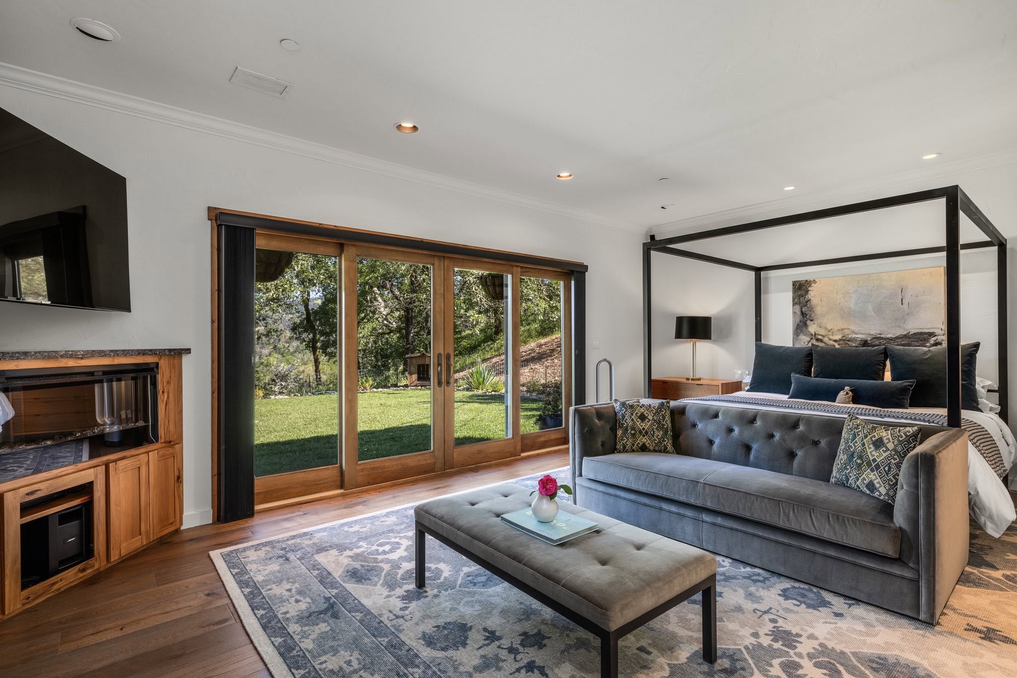 Bedroom suite with seating area and outdoor view